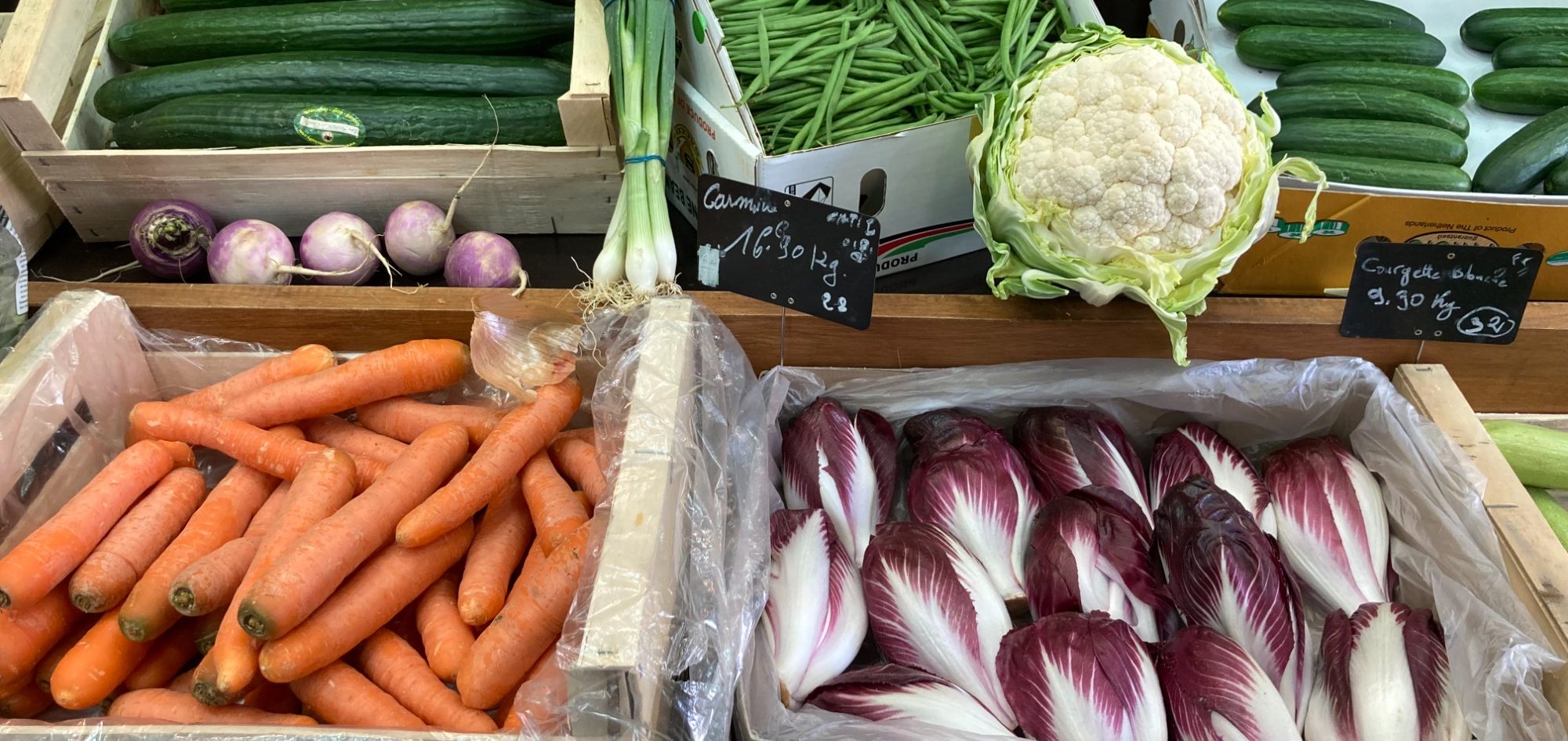 Fresh carrots, cucumbers, green beans, cauliflower, endives, turnips, spring onions on display at the Poèmes des 4 Saisons shop in Paris